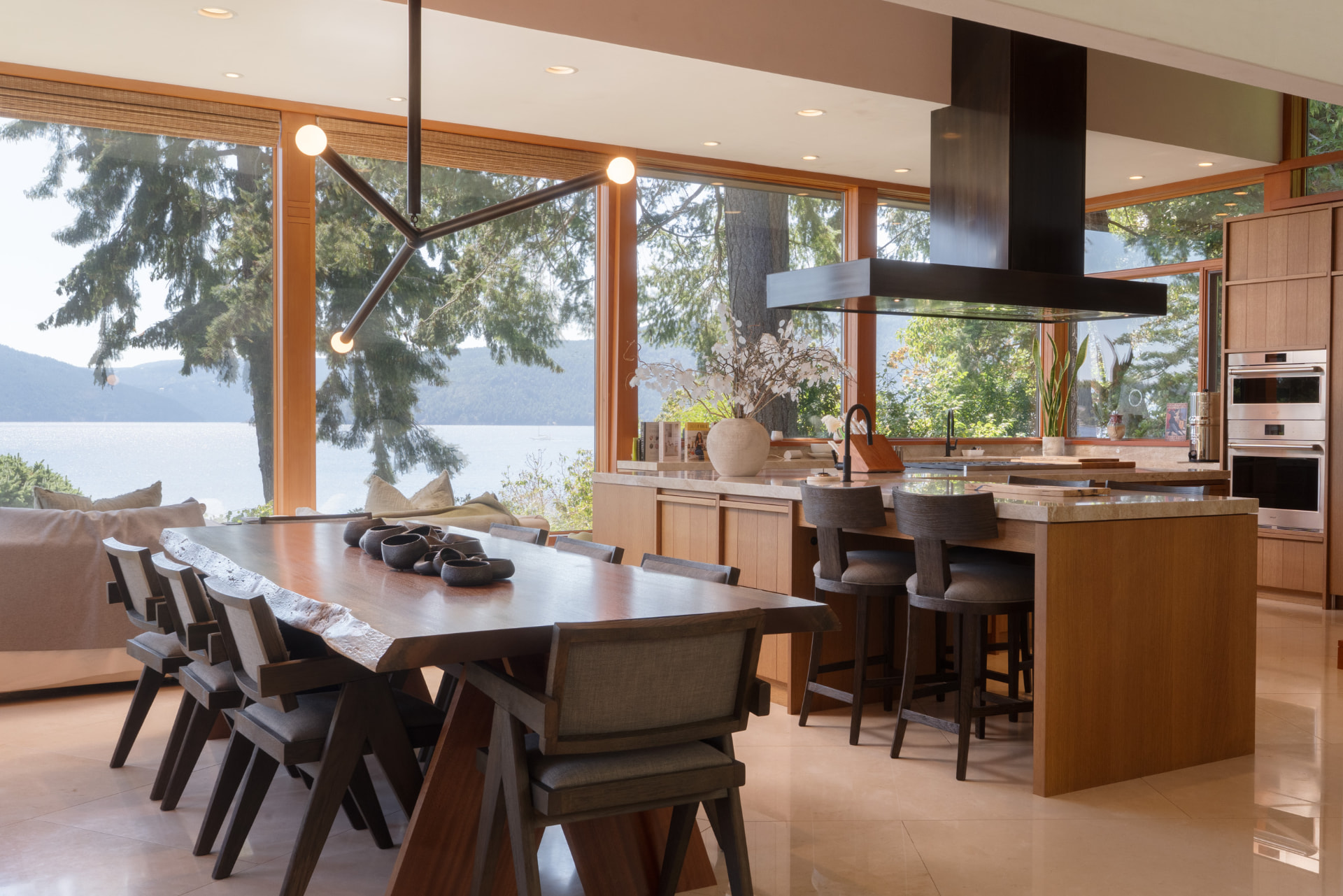 Waterfront dining room and kitchen with live-edge table and ocean views