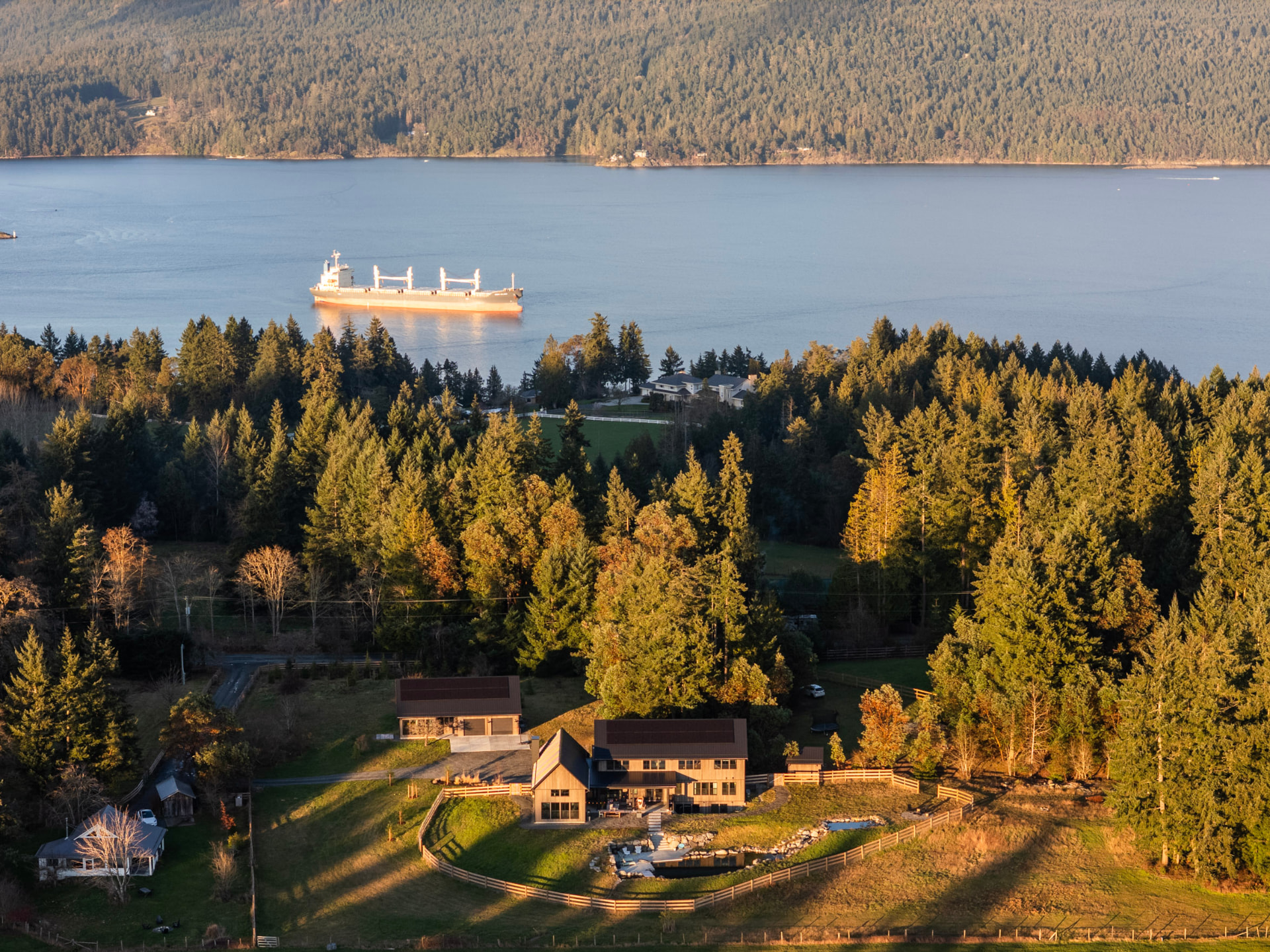 Aerial view of an oceanfront acreage with a freighter on the inlet